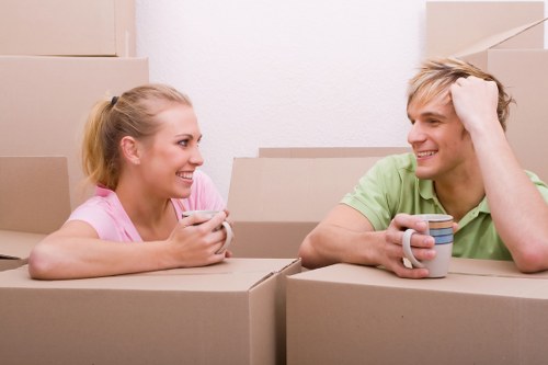 Movers carrying furniture through a residential property in Hayes