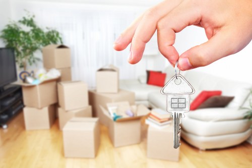Professional movers carrying furniture from a family home in Hayes